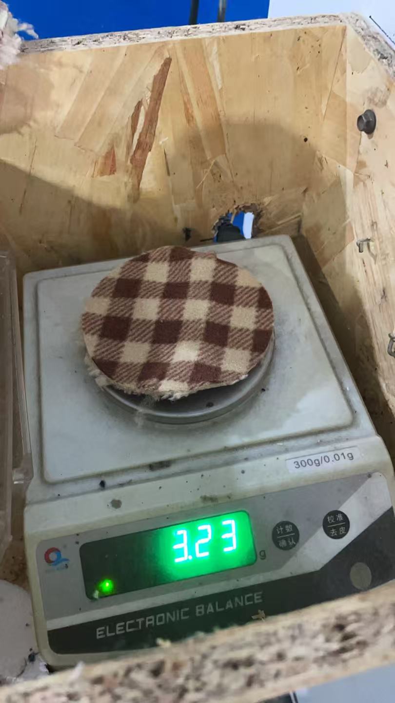 Weight test photo — brown plaid sample; visible scale reading 3.23 g. Cut area and GSM calculation not shown.